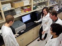 Left to right; William Denk, Anya Todic, John Brennan and Kevin Yin using the Infinite M200 PRO microplate reader